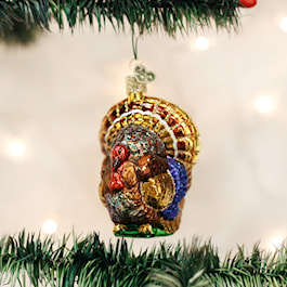 Old World Christmas Tom Turkey mouth-blown glass ornament with gold, red, blue and brown feathers