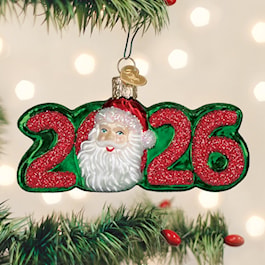 Old World Christmas 2026 Santa glass ornament with glittered red numbers and Santa's smiling face on green