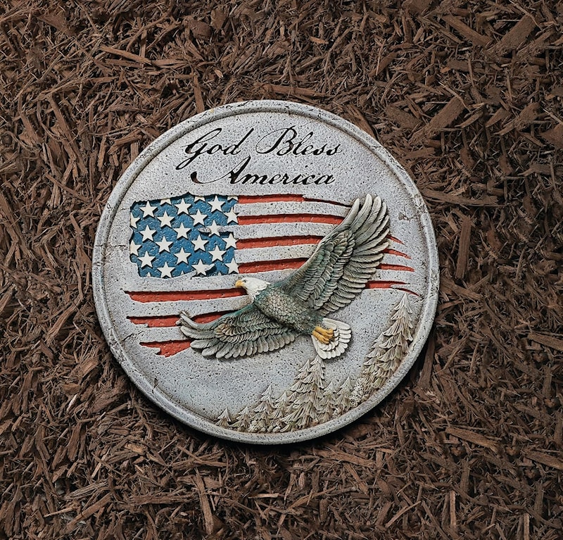 Roman God Bless America garden stone with a bald eagle in flight over an American flag